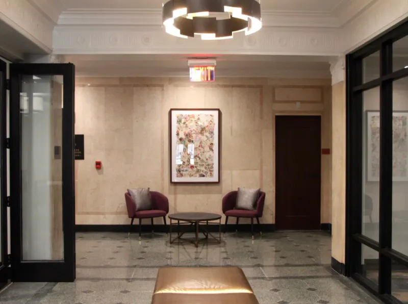Formal municipal building lobby with smooth plaster-finished stone-panel walls, a coffered plaster ceiling, and a terrazzo floor, Worcester, MA