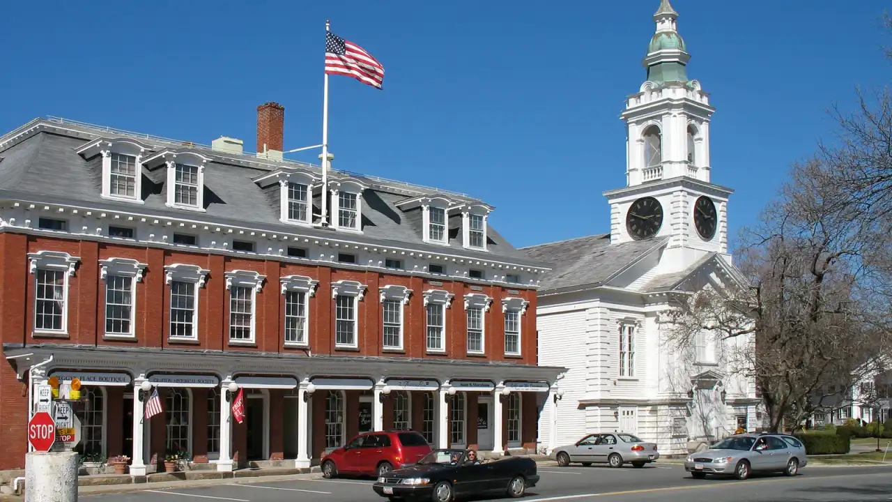 Historic brick commercial block and white church tower on the town common, Grafton, Massachusetts